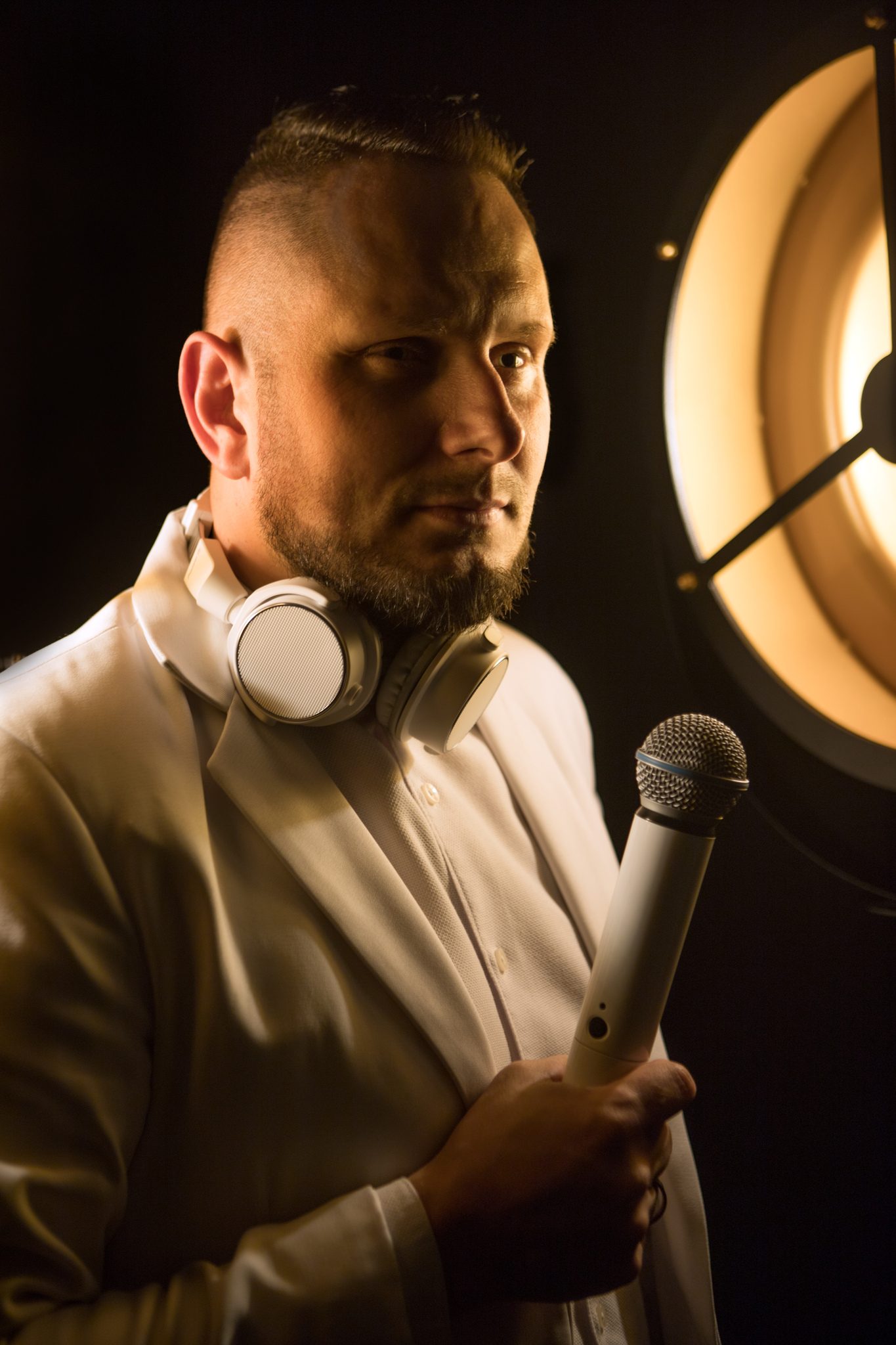 DJ Perszol — Daniel Wojsa w białym garniturze z mikrofonem